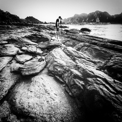 Black and white of a rocky beach. Slight grain.