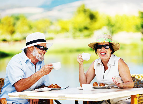 istock Happy senior couple relaxing over tea at lakeside cafe 143177370