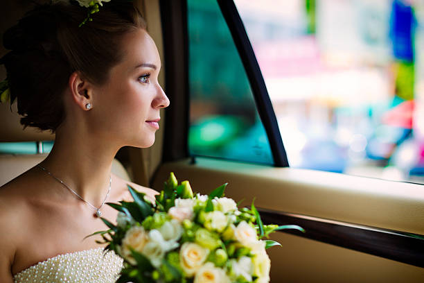 Young bride sitting in the car