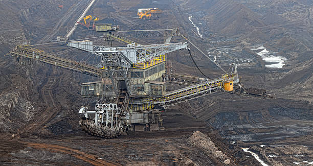 istock Open Strip Coal mine with Bucket-wheel excavator at conveyor belt 143177825