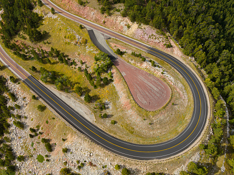 Aerial drone photograph of a hairpin turn on Highway 14 in the Bighorn Mountains. Photographed near the Hogbacks area in Wyoming.