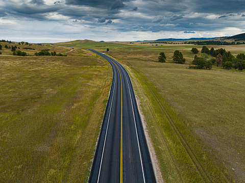 Aerial drone photograph of Highway 24 in rural Wyoming. Photographed near Devil's Tower National Monument outside of Hulett, Wyoming.