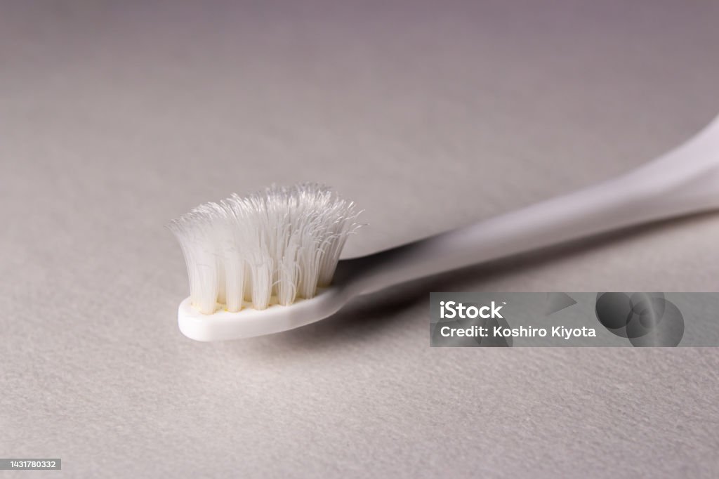 Closeup old toothbrush on white background Closeup old toothbrush on white background. Toothbrush's bristles are worn out. Bathroom Stock Photo