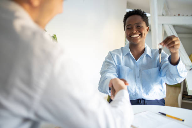 istock Real estate agent passing keys to his client 1431790883