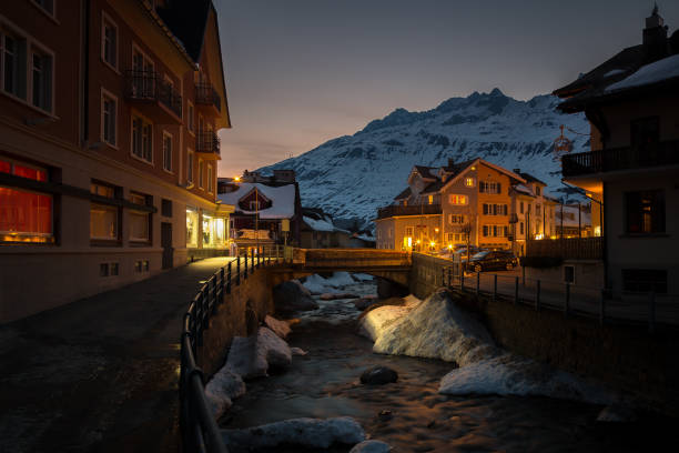 Andermatt Unteralpreuss river in the center of Andermatt in the Canton of Uri at dusk. yt stock pictures, royalty-free photos & images