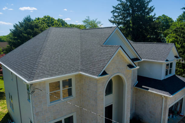 An asphalt shingle roof part in a new home is being renovated stock photo