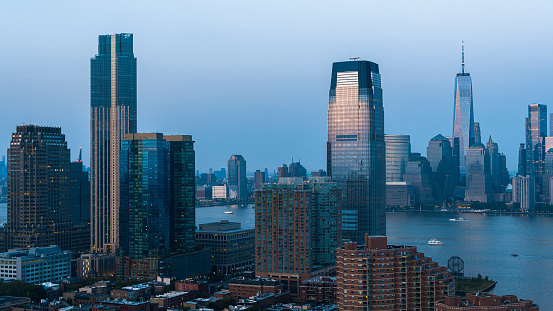 Modern skyscraper in Paulus Hook, Jersey City with the Hudson River and Downtown Manhattan view.