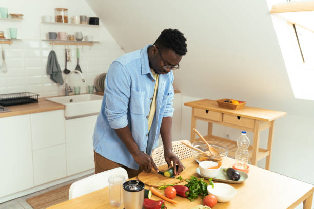 istock A young African-American man prepares a meal 1431802021