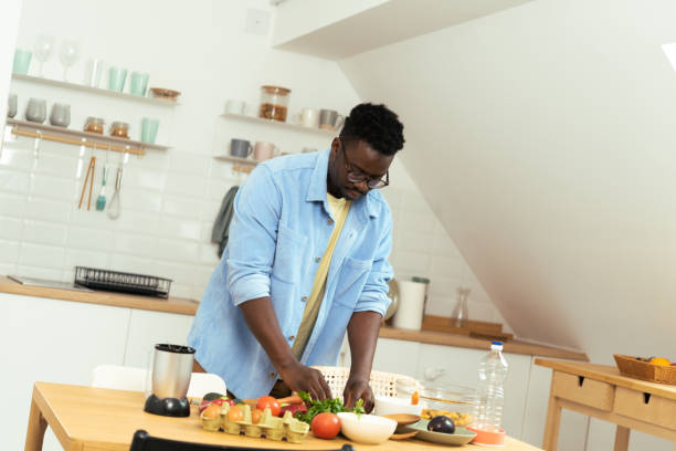 istock A young African-American man prepares a meal 1431802022