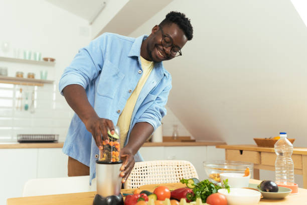 istock A young African-American man prepares a meal 1431802051