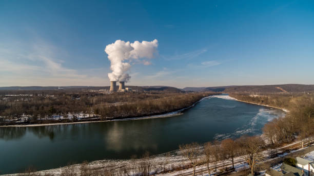 A nuclear power plant on the banks of the Susquehanna River, Pennsylvania, during a sunny winter day. Nuclear power generation plant in Pennsylvania on a sunny winter day. cooling tower photos stock pictures, royalty-free photos & images