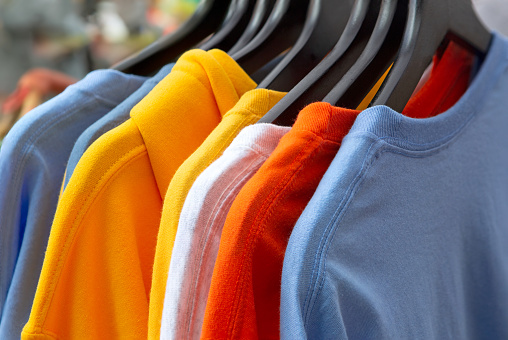 Colorful t-shirts for sale at a local outdoor shopping bazaar