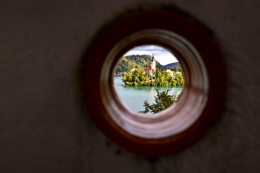 Lake Bled Island in Slovenia provides a fairy tale scene for all those lucky to view it. This unique view of the Santa Maria Church on the island is through a hole on the porch of a vacation rental.