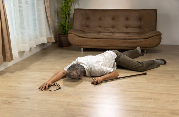 istock Asian senior man falling down and lying on the floor while walk with walking stick at home. 1431824080