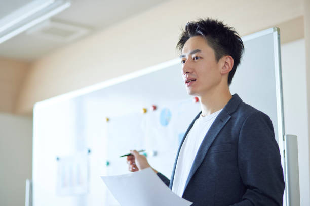 istock Young Japanese business giving a presentation 1431838527