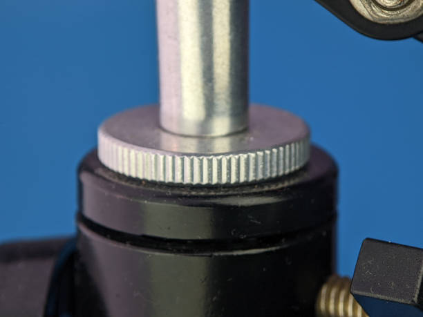 istock Closeup microphone mounting screw on a blue background. 1431838617