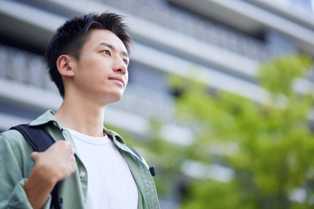 大学キャンパスと日本人の若手学生 - 若い男性一人 ストックフォトと画像