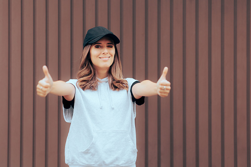 Cheerful woman giving positive feedback with nonverbal communication gesture