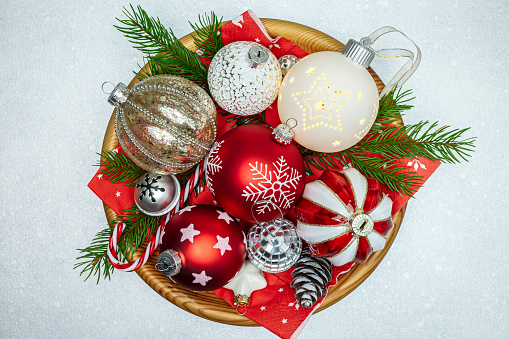 christmas table decorations with colorful glass balls, stars and fir branches with cone