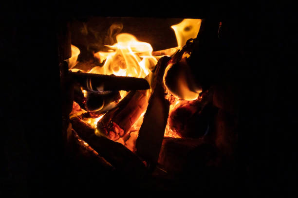 Light a firewood in the dark. orange flame