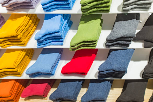 istock Multi colored socks stacked on shelves in the store 1431849696