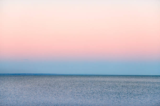 istock Atmospheric romantic pink red sea sunset sky above blue quiet water, minimalistic peaceful seascape 1431855372
