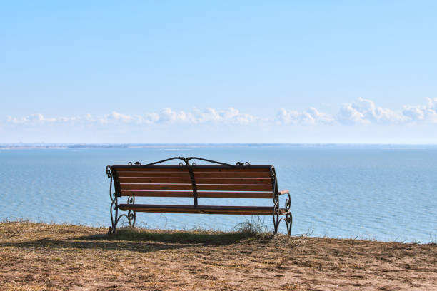 istock Empty bench on cliff before sea background, peaceful and quiet place for thinking alone 1431855444