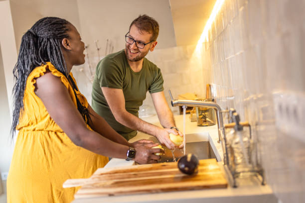 istock Multi ethic couple preparing food together in the kitchen 1431858283