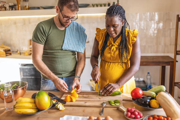 istock Multi ethic couple cooking together at home 1431858448