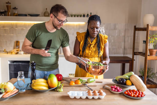 istock Future parents in the kitchen while preparing a salad for lunch 1431858880