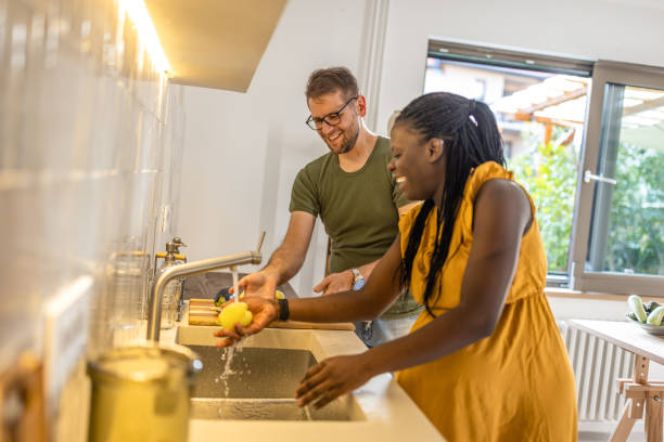 istock Multi ethic couple preparing food together in the kitchen 1431859133