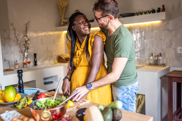 istock Multi ethnic couple cooking together at home 1431860357