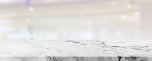 istock Empty white marble stone table top and blur glass window interior shop and store banner mock up abstract background - can used for display or montage your products. 1431860487