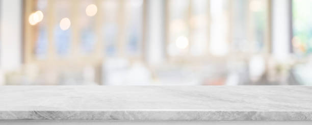 istock Empty white marble stone table top and blur glass window interior cafe and restaurant banner mock up abstract background - can used for display or montage your products. 1431860622