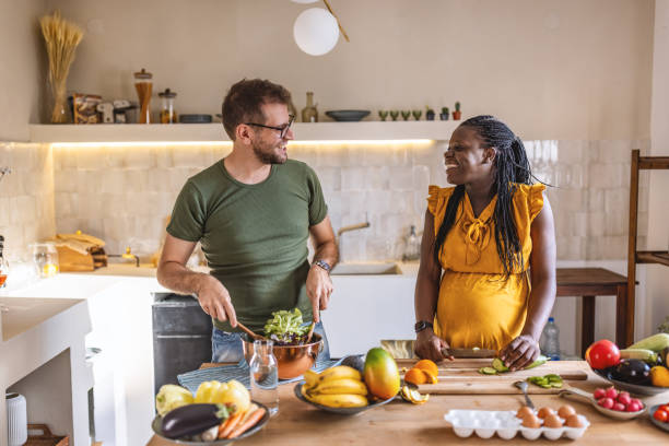 istock Happy multi ethnic couple cooking together at home 1431860663