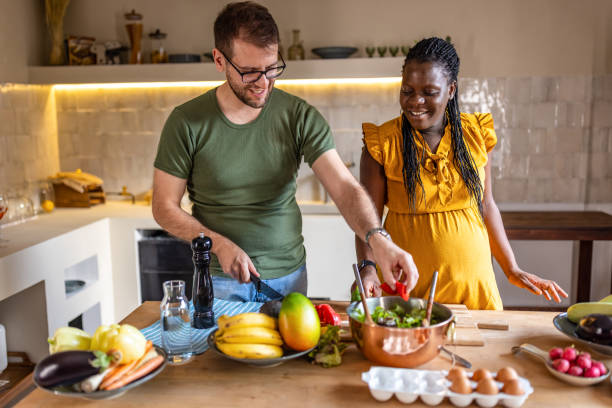 istock Happy multi ethnic couple cooking together at home 1431861161