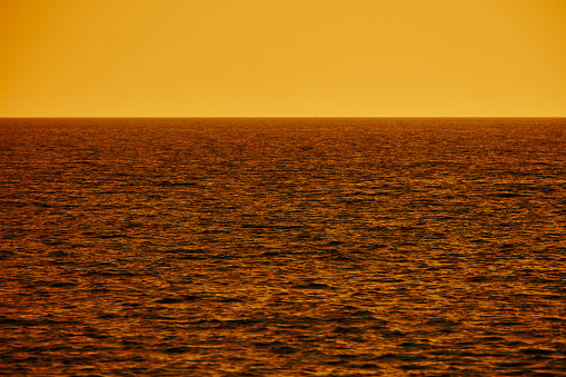 Ocean sea sunlight reflection and distant horizon.