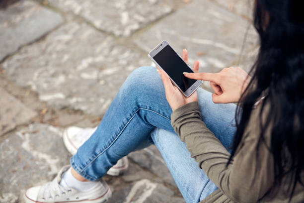 istock Young cute female using smartphone on the street. 1431879516