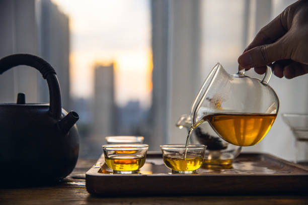 istock Hand pouring Chinese tea into glass cup 1431884237