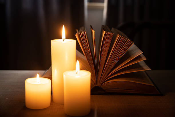 istock A open book on the table in the light of candle 1431884395