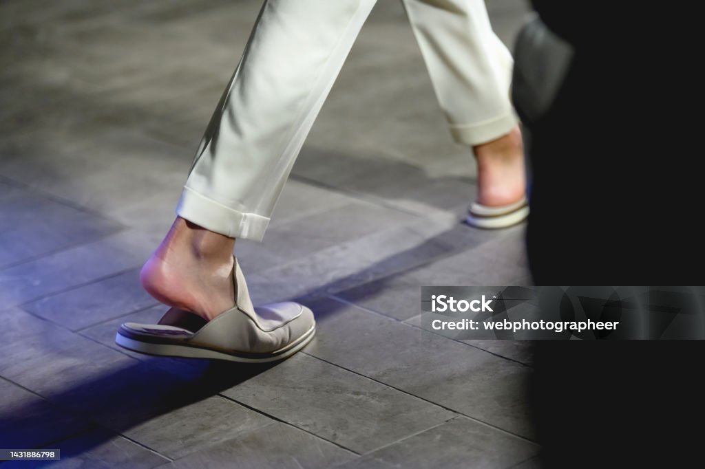 New collection of slippers for men Low section of male fashion model walking on catwalk in sandals during fashion week Foot Stock Photo