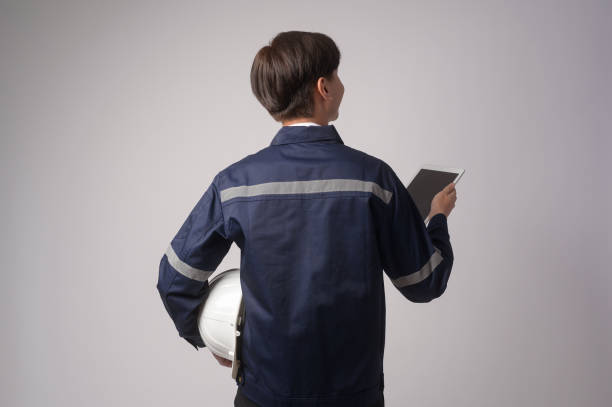 istock Portrait of male engineer wearing a protective helmet over white background studio. 1431887125
