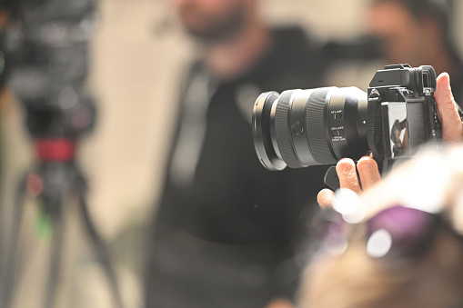 Photojournalist at a press conference, copy space