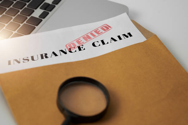 Document and magnifying glass on white table, Document with denied stamp and magnifying glass put on the laptop on white table, insurance stock pictures, royalty-free photos & images