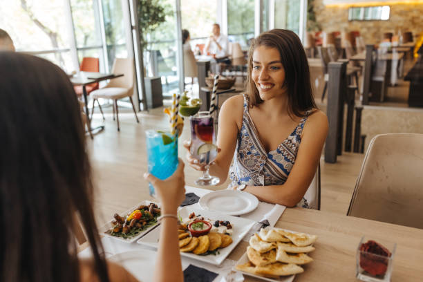 istock Two young female friends enjoying lunch in restaurant 1431890187