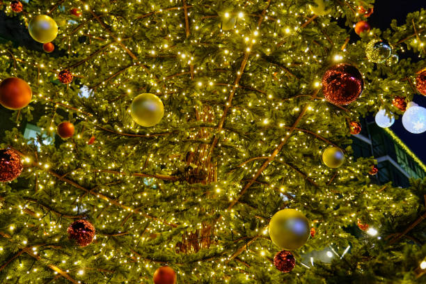 istock Red and gold Christmas decorations hanging on the Christmas tree illuminated with lights 1431894760