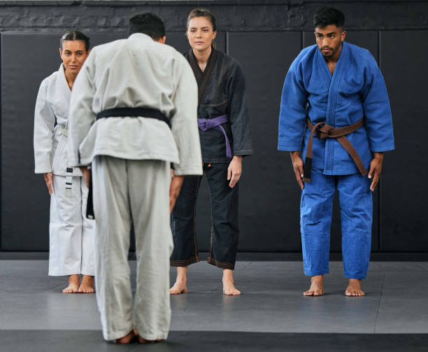 istock Karate coach teaching a fitness class at gym, students learning self defense training exercise with trainer and doing cardio workout at sports center. Healthy people doing martial arts hobby 1431895904