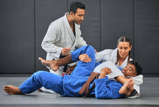 istock Mma, martial arts and exercise with a coach, teacher or instructor instructing students during practice, training or sparring in a gym or dojo. Fighting and self defense class for health and fitness 1431895923