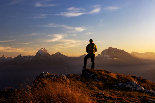 Mountaineer in the Alps standing on Berchtesgadener Hochthron mountain with a view of Watzmann stock photo