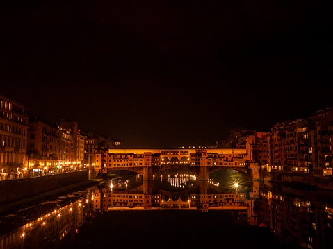 Florence, Italy - November, 2011: ponte vecchio is glowing even in the dark night.